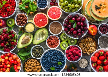 Selection of healthy food. Superfoods, various fruits and assorted berries, nuts and seeds. Royalty-Free Stock Photo #1234505608