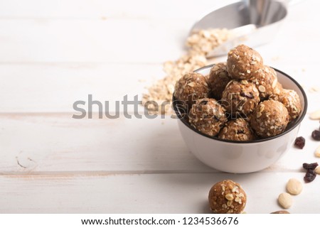 If you have a question how to make the no bake energy bites - just mix all ingredients, such as nuts, cocoa, chocolate, oats together in a large bowl until combined. Wooden background Royalty-Free Stock Photo #1234536676