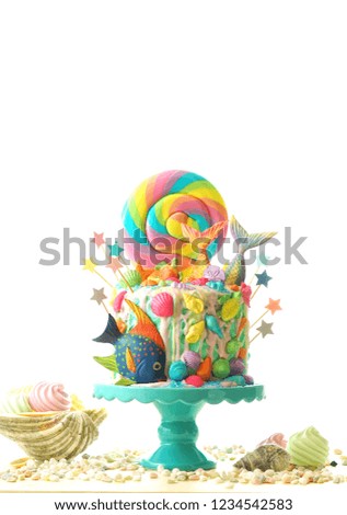 Mermaid theme candyland cake with colorful glitter tails, shells and sea creatures toppers for children's, teen's, novelty birthday and party celebrations.