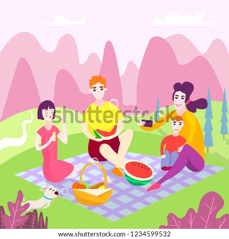 Family picnic in the park. Spring vacation. Happy family with children. They sit and eat watermelon on the grass in the park, a basket with food and toys for children. make selfies. 