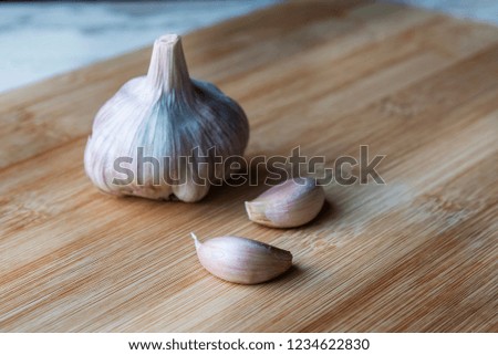 Organic Garlic on wooden background with copy space. Healthy food concept.