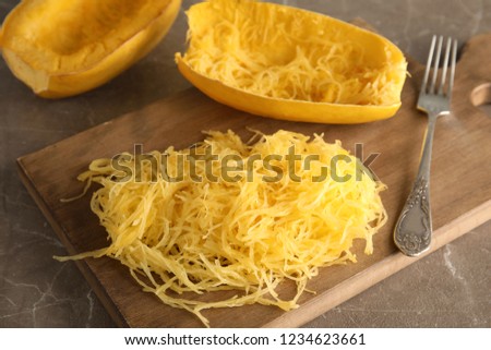 Cooked spaghetti squash and fork on wooden board Royalty-Free Stock Photo #1234623661