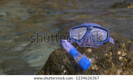 a mask and snorkel on the beach near the sea