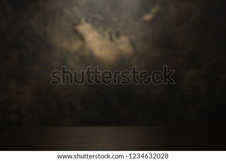 blurred decorative plaster background texture with wooden shelf at the bottom of the photo
