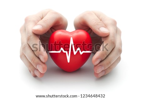 Red heart with pulse covered by man's hands.