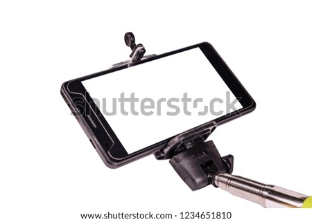 Selfie stick with modern smartphone isolated on white background