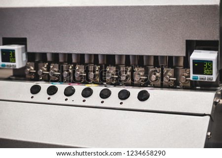 Close-up of inkjet printers in large machines.