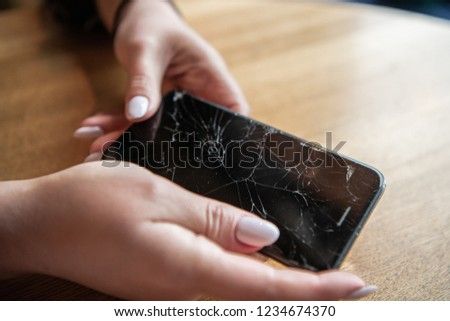 Modern mobile smartphone broken screen and damages.
