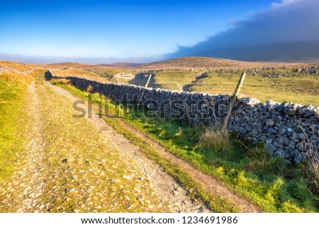 Pen-y-ghent is one of the famous 'Three Peaks' of Yorkshire with a distinctive shape especially when seen from the south west approach. ... The walk starts in the village of Horton in Ribblesdale Royalty-Free Stock Photo #1234691986