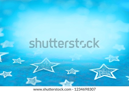 textile background with stars and blurry turquoise copy space. christmas backdrop.