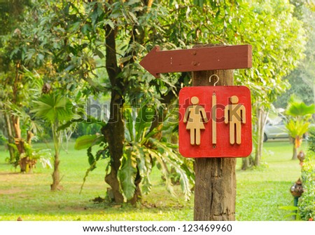 Wooden Sign pointing direction go to toilet