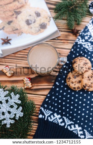 Christmas and New Year pattern. Christmas tree, cup of coffee, cookies with chocolate, anise, sweeter and recipe of cookies are lying on the wooden brown background.