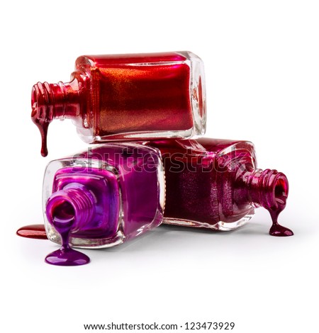 Stack of bottles with spilled nail polish over white background Royalty-Free Stock Photo #123473929