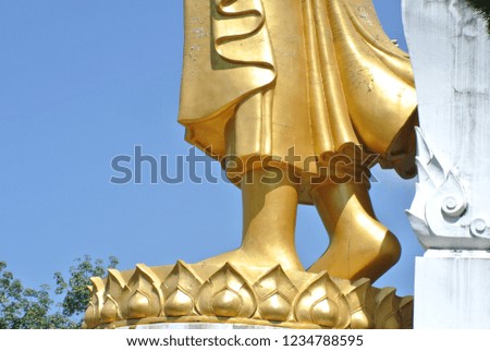 Legs of Buddha on blue sky background