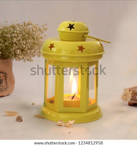 Candle glowing in a lamp 