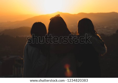 
girls watching the sunset