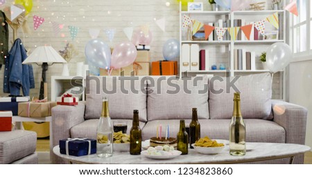Room with festive balloons colorful banners. decorated house party celebration for christmas and new year. cozy home with drinks food and birthday cake on marble table.