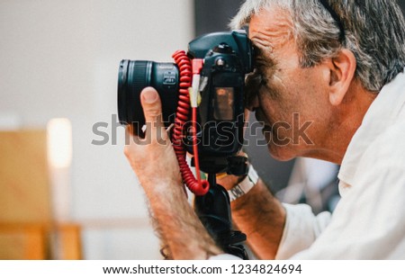 Senior photographer taking a shot