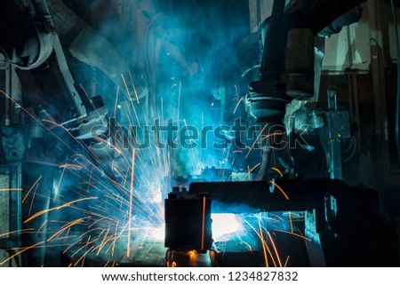  industrial robot are welding in factory

