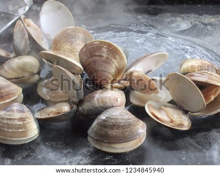 cooking clams at BBQ Royalty-Free Stock Photo #1234845940