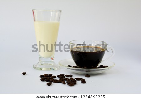 Cup of hot black coffee, coffee bean, glass of milk. Concept time to relax.