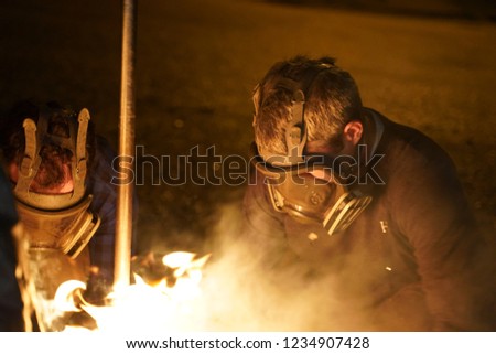 Men in Gas Masks with Flames 