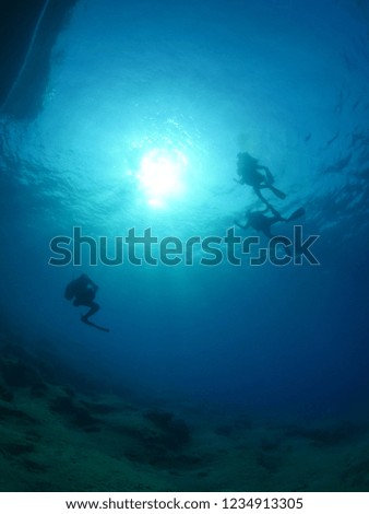 scuba diver underwater with sun ray and beam