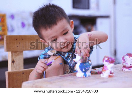 Asian kid  playing colorful toys