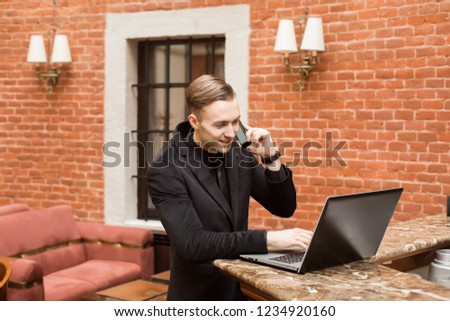 young successful businessman with laptop and phone