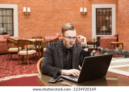 young successful businessman with laptop and phone