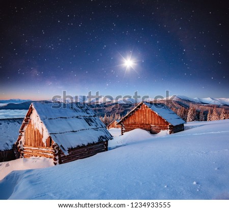 View at the starry sky over snowy hills. Dramatic and exotic scene. Location place Carpathian mountains, Ukraine, Europe. Astrophotography of milkyway. Winter wallpaper. Discover the beauty of earth.