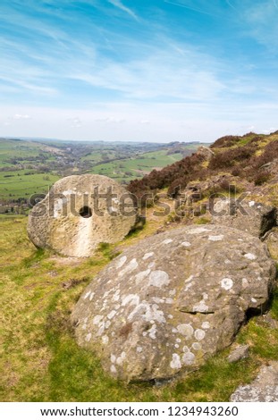 Abandoned old millstones on Curbar Edge in the Derbyshire Peak District, UK
