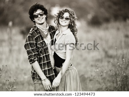Picture of vintage way dressed yang pretty couple outdoor.