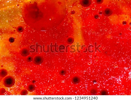 Interesting abstract background in red and yellow. The effect obtained by mixing water, cooking oil and food coloring.