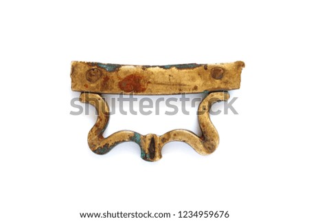 Antique bronze handle on white. Beautiful gold color decorative element close-up photo.