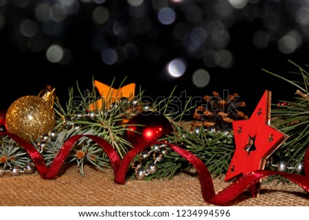 beautiful new year background with Christmas toys and fir branches on a black background
