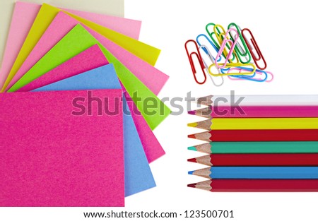 Colorful pencils, clips  and note papers on white background