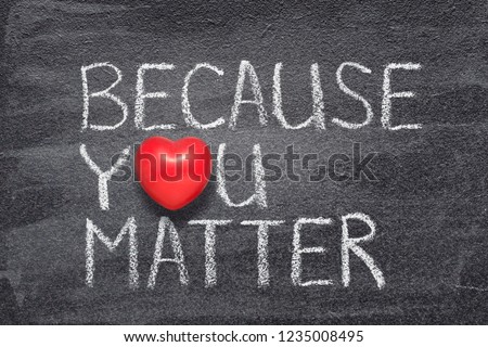 because you matter phrase handwritten on chalkboard with red heart symbol instead of O
