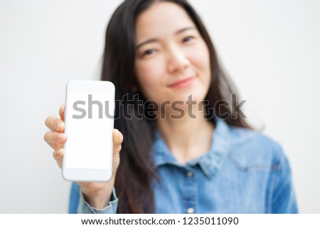mockup image of woman's hand holding texting white cell phone on white background with copy space,blank screen for text.concept for business,people communication,technology electronic device.mo