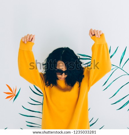 Beautiful and cute woman in accessories and sweatshirt. Stylish Hoody yellow trendy vibes