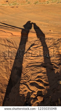 Kissing couple's shadow over dessert