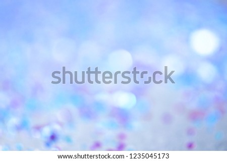 Winter abstract background. Blue, white and purple blurred circles.