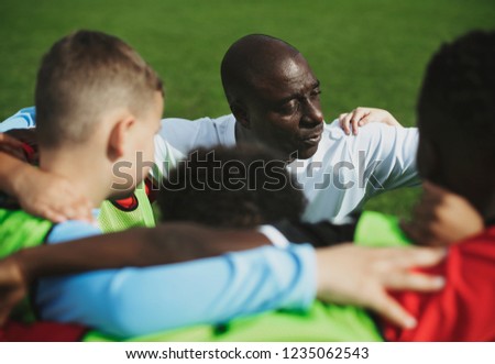Football players huddle before a match