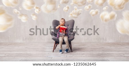 Little child eating popcorn in the cinema