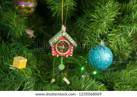Wooden toy clock with pendulum on Christmas tree