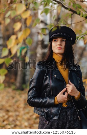 cozy stylish young girl walk at autumn colorful park alone make photos