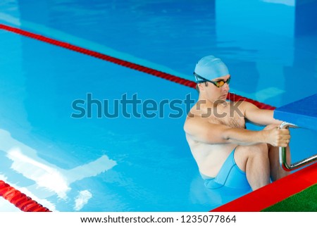 Image of athlete swimmer at side in pool