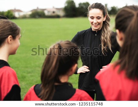 Junior rugby players and their coach Royalty-Free Stock Photo #1235115748