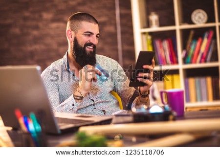 Designer working in office using credit card for online payment