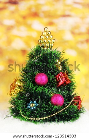 Decorated artificial Christmas Tree on bright background